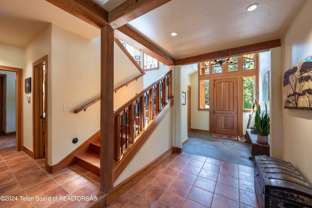 155 E Buck Mountain Rd, Jackson, WY 83001 - foyer with baseboards, beam ceiling, and stairway