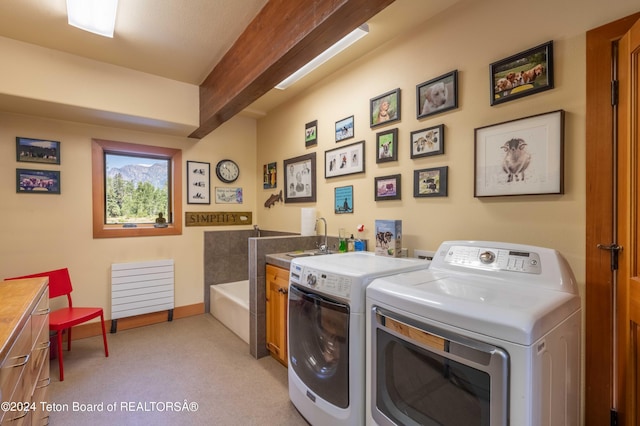 155 E Buck Mountain Rd, Jackson, WY 83001 - washroom featuring baseboards, cabinet space, a sink, and separate washer and dryer
