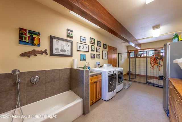 washroom featuring sink, washer and clothes dryer, a textured ceiling, and light carpet