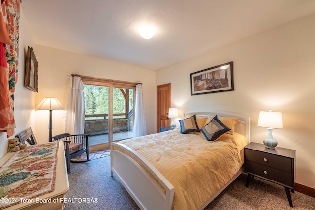 155 E Buck Mountain Rd, Jackson, WY 83001 - carpeted bedroom featuring baseboards and access to exterior