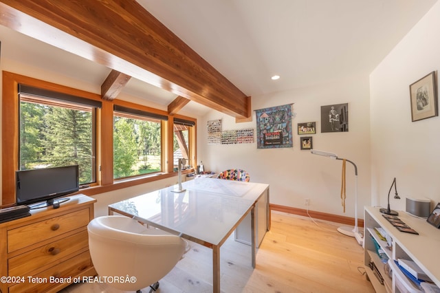 home office with beamed ceiling and light wood-type flooring