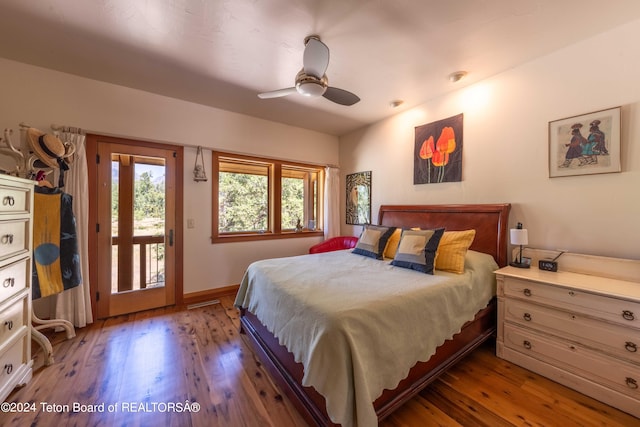 bedroom featuring ceiling fan, wood-type flooring, and access to exterior