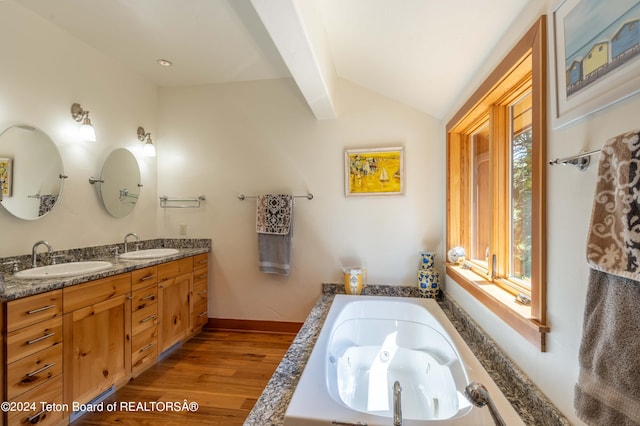 bathroom featuring vaulted ceiling with beams, hardwood / wood-style flooring, a bath, and dual vanity