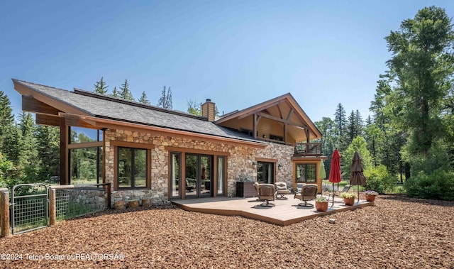 155 E Buck Mountain Rd, Jackson, WY 83001 - rear view of property featuring a balcony, a chimney, french doors, and roof with shingles