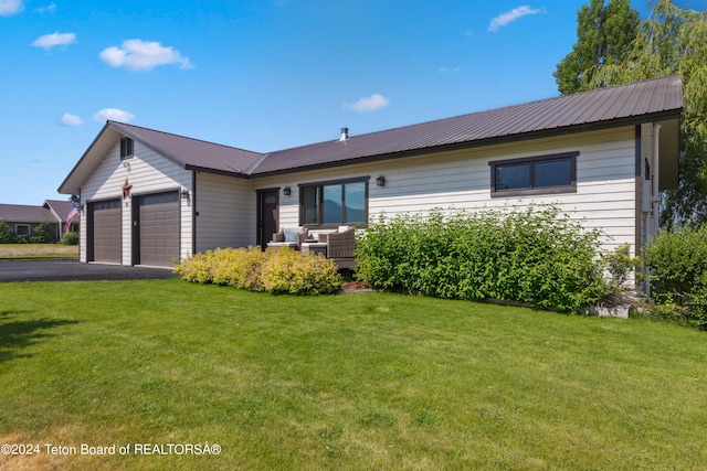 single story home with a garage and a front yard