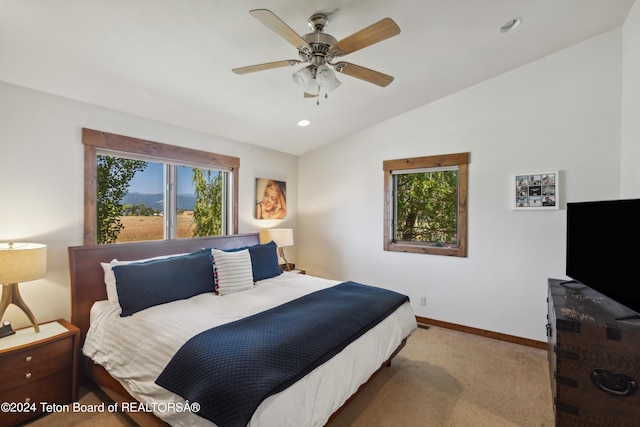 carpeted bedroom with lofted ceiling, multiple windows, and ceiling fan