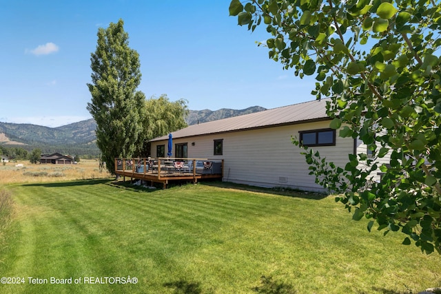 view of yard featuring a deck with mountain view