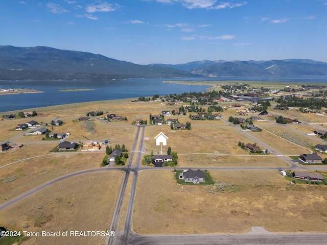 bird's eye view with a water and mountain view