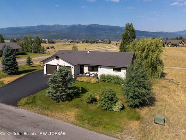 view of front of home featuring a mountain view and a garage