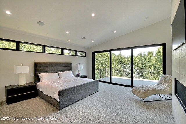 carpeted bedroom with access to outside and vaulted ceiling