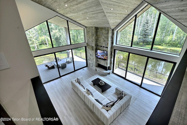 6 Blackfoot Trl, Victor, ID 83455 - living room featuring a wealth of natural light, wood finished floors, a stone fireplace, and a towering ceiling