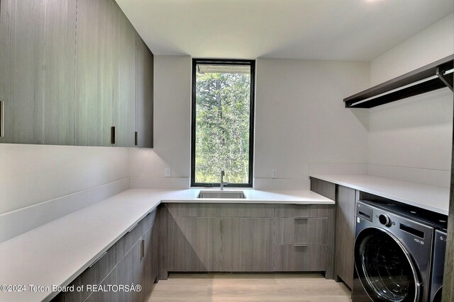 laundry room featuring washer / dryer and sink