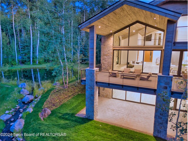 back of house with a patio area and a balcony