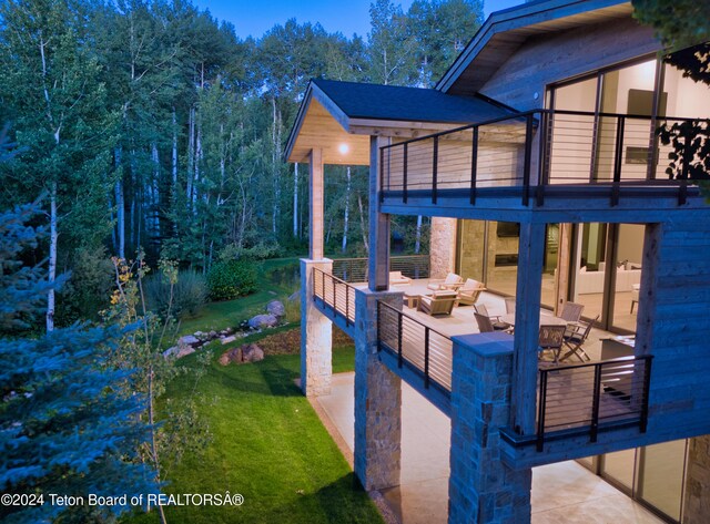 exterior space with outdoor lounge area and a balcony