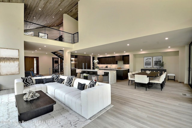 6 Blackfoot Trl, Victor, ID 83455 - living room with stairway, a towering ceiling, recessed lighting, and light wood finished floors