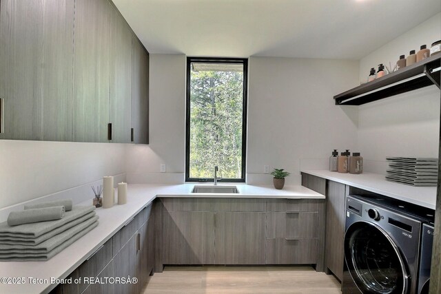 6 Blackfoot Trl, Victor, ID 83455 - clothes washing area with laundry area, washer / clothes dryer, light wood-type flooring, and a sink