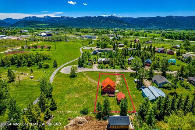 birds eye view of property featuring a mountain view