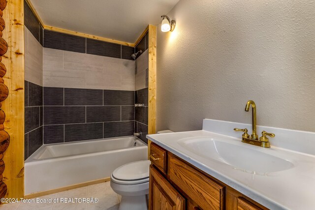 full bathroom featuring tile patterned flooring, vanity, tiled shower / bath combo, and toilet