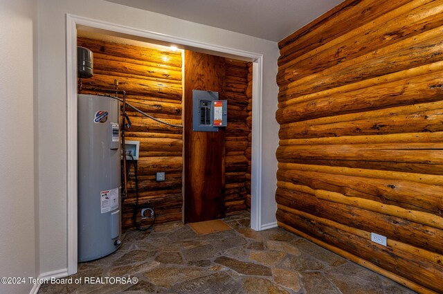 utility room with electric water heater and electric panel