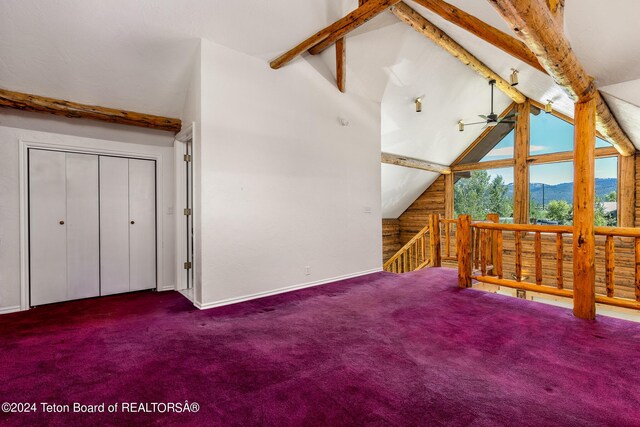 bonus room with a mountain view, carpet, high vaulted ceiling, wooden walls, and beam ceiling