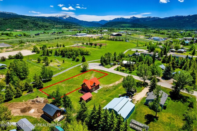 birds eye view of property featuring a mountain view