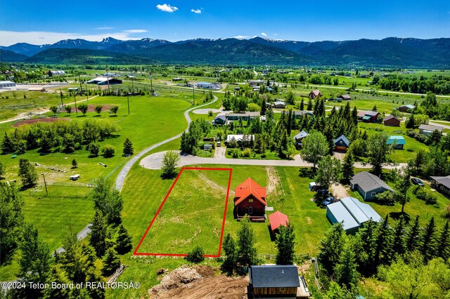 birds eye view of property with a mountain view