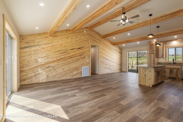 1424 Fairview Dr, Dubois, WY 82513 - kitchen featuring open floor plan, wood walls, dark wood-type flooring, dark countertops, and a ceiling fan