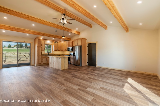 unfurnished living room featuring vaulted ceiling with beams, light wood-type flooring, and ceiling fan