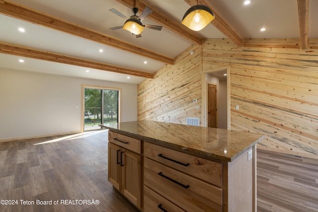 1424 Fairview Dr, Dubois, WY 82513 - kitchen featuring wood walls, dark wood-style flooring, dark stone countertops, a center island, and open floor plan
