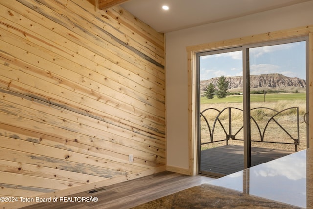 1424 Fairview Dr, Dubois, WY 82513 - empty room with a mountain view, wood finished floors, wooden walls, and recessed lighting