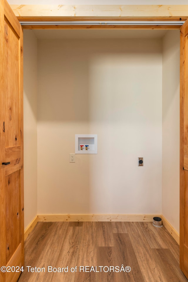 laundry area with wood-type flooring, electric dryer hookup, and washer hookup