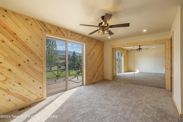 1424 Fairview Dr, Dubois, WY 82513 - carpeted empty room with wooden walls, a ceiling fan, and recessed lighting