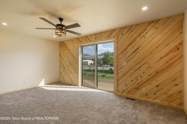 1424 Fairview Dr, Dubois, WY 82513 - unfurnished room with carpet floors, recessed lighting, wooden walls, and ceiling fan