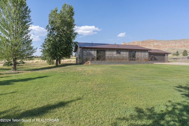 1424 Fairview Dr, Dubois, WY 82513 - view of green lawn with driveway and an attached garage