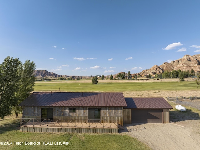 1424 Fairview Dr, Dubois, WY 82513 - view of front of home with a mountain view, a metal roof, a front yard, and gravel driveway