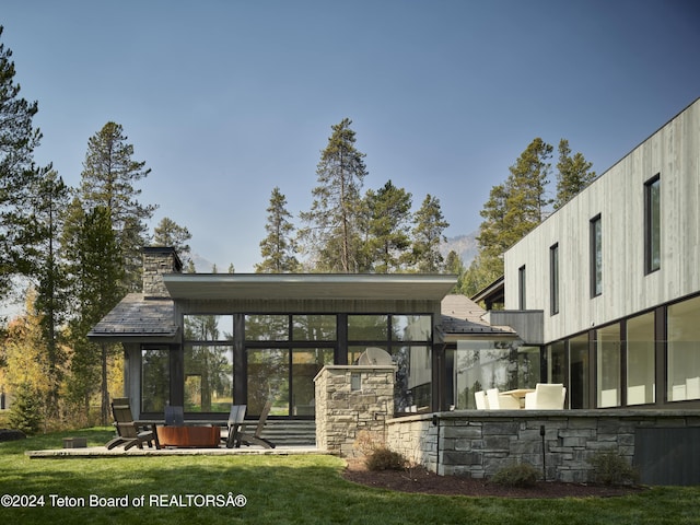 7750 N Lower Granite Ridge Rd, Teton Village, WY 83025 - rear view of property featuring a sunroom, a yard, and a chimney