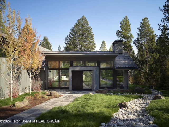 7750 N Lower Granite Ridge Rd, Teton Village, WY 83025 - doorway to property featuring a chimney and a yard