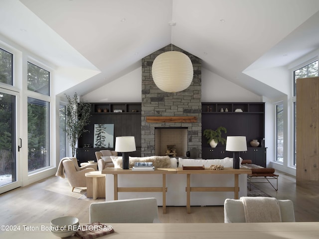 7750 N Lower Granite Ridge Rd, Teton Village, WY 83025 - living room with wood finished floors, a fireplace, and lofted ceiling