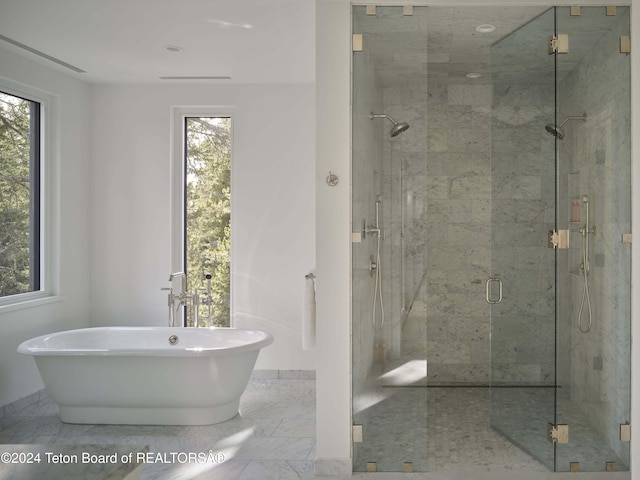 7750 N Lower Granite Ridge Rd, Teton Village, WY 83025 - full bathroom with a soaking tub, a marble finish shower, and healthy amount of natural light
