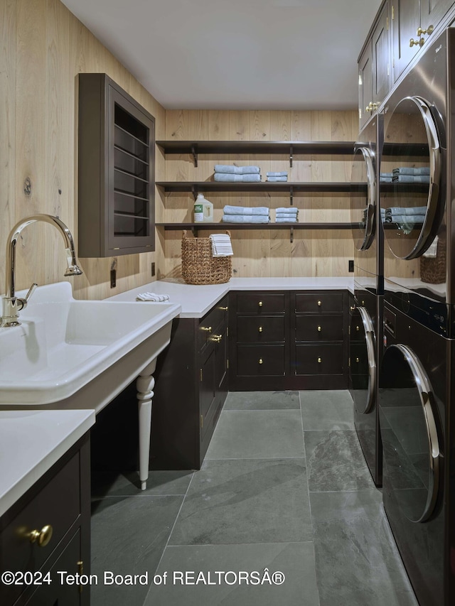 7750 N Lower Granite Ridge Rd, Teton Village, WY 83025 - laundry room featuring cabinet space, wooden walls, and washing machine and dryer