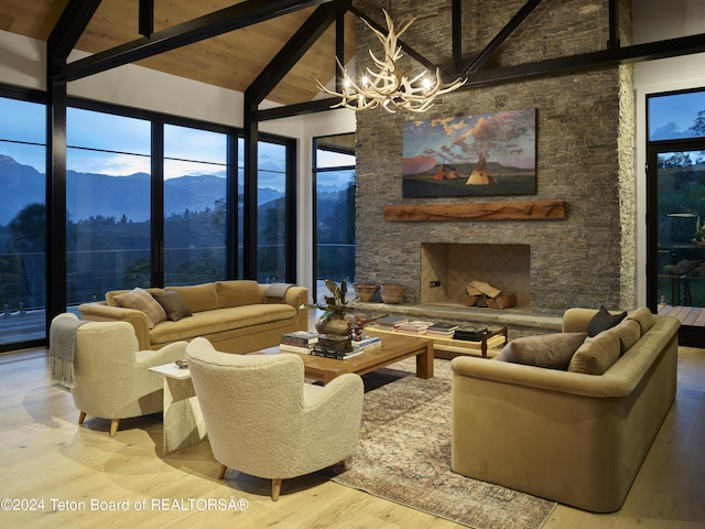 living room featuring beam ceiling, a mountain view, wood-type flooring, and a fireplace