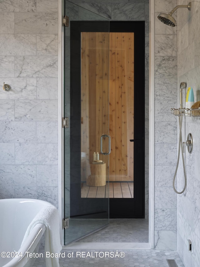 bathroom featuring tile patterned flooring and plus walk in shower