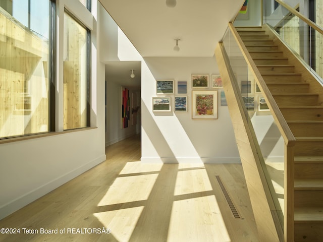 stairs featuring light wood-type flooring