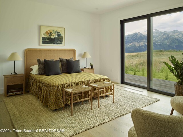 2680 Trader Rd, Jackson, WY 83001 - bedroom featuring multiple windows, access to outside, and wood finished floors
