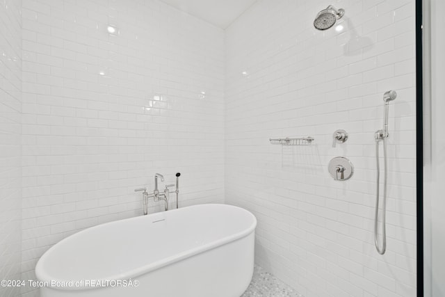 2680 Trader Rd, Jackson, WY 83001 - full bathroom featuring a soaking tub, tile walls, and tiled shower