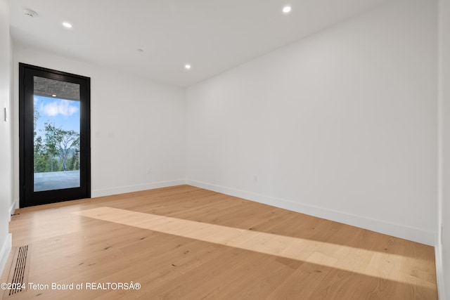 unfurnished room with light hardwood / wood-style floors