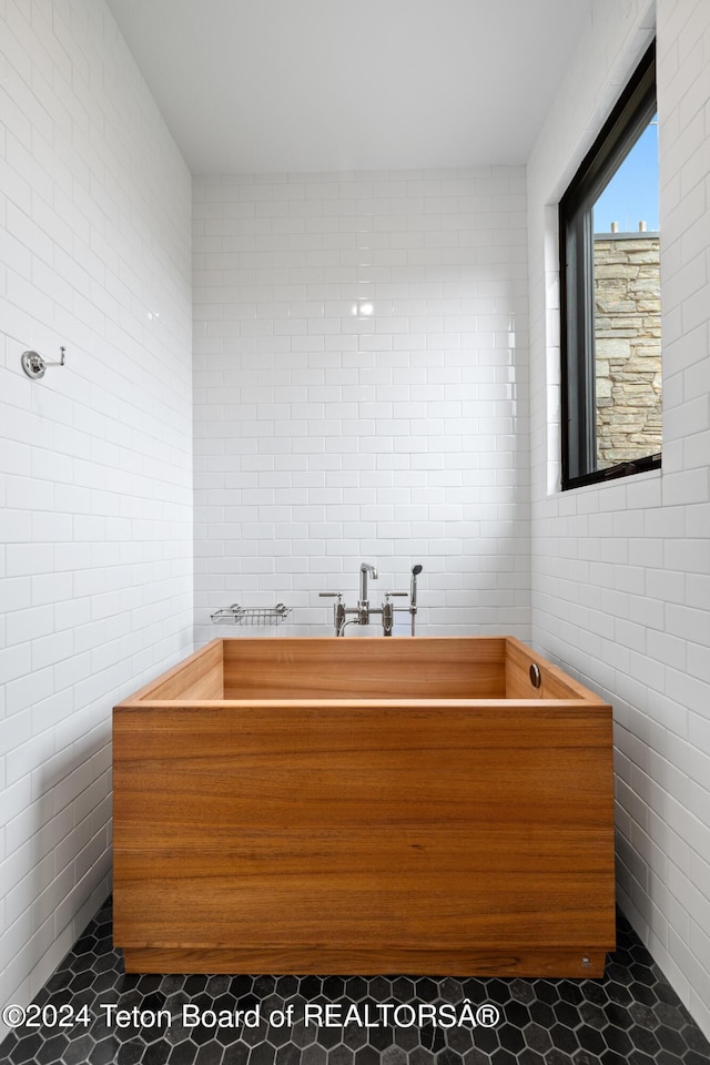 2680 Trader Rd, Jackson, WY 83001 - full bath with tile patterned floors, tile walls, and a bathing tub