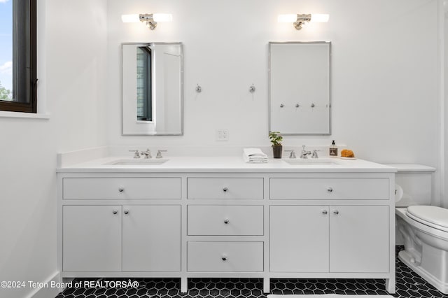 2680 Trader Rd, Jackson, WY 83001 - full bathroom featuring toilet, double vanity, and a sink