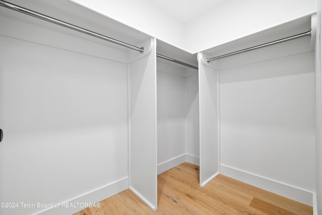 spacious closet featuring light hardwood / wood-style floors