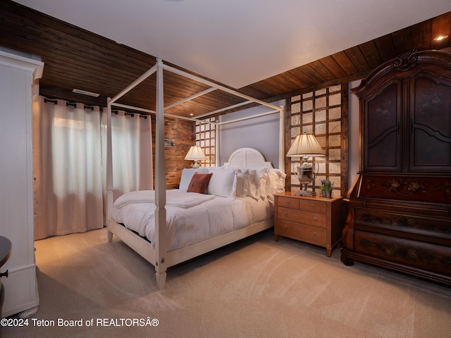 carpeted bedroom featuring wooden ceiling